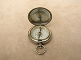 A late Victorian hunter cased pocket compass with cross bar needle
